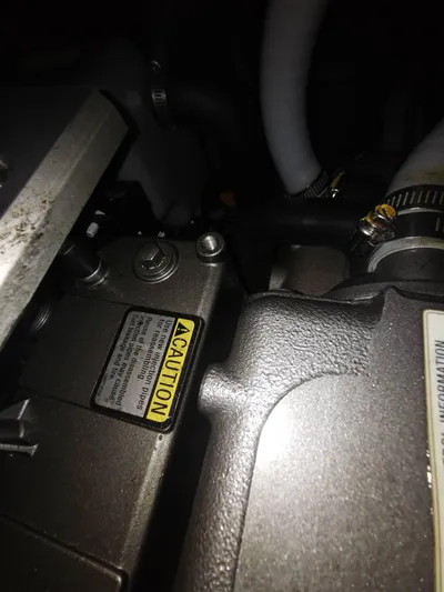 Siman H Yacht Photos Pics Close-up of 2020 Beneteau Oceanis 46.1 engine components with caution label.