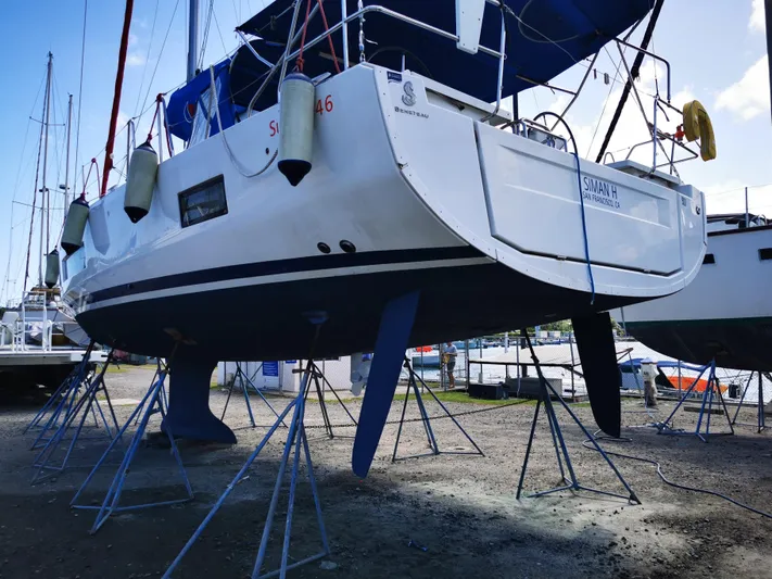 Siman H Yacht Photos Pics Beneteau Oceanis 46.1 sailboat on stands, 2020 model, in a marina setting.