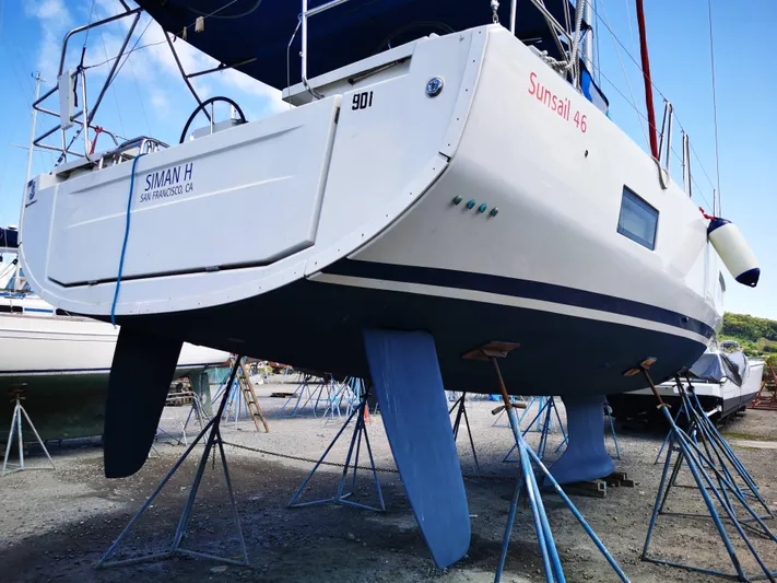 Siman H Yacht Photos Pics 2020 Beneteau Oceanis 46.1 sailboat on stands, viewed from the stern in a boatyard.