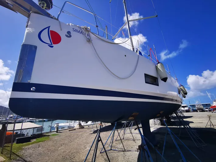 Siman H Yacht Photos Pics Beneteau Oceanis 46.1 sailboat on stands, 2020 model, in a sunny marina setting.