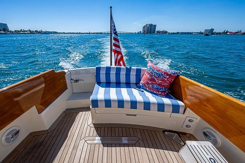 Odelay Yacht Photos Pics 2016 Hinckley Picnic Boat MKIII cruising with striped seating and American flag.