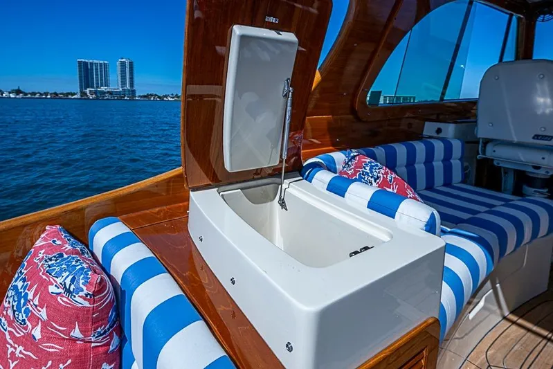 Odelay Yacht Photos Pics 2016 Hinckley Picnic Boat MKIII interior with striped seating and open storage compartment.