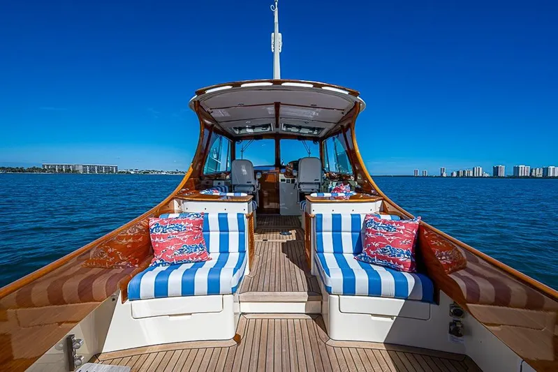 Odelay Yacht Photos Pics 2016 Hinckley Picnic Boat MKIII on water, featuring striped seating and vibrant cushions.