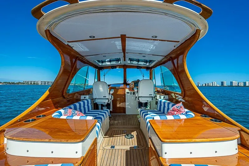 Odelay Yacht Photos Pics 2016 Hinckley Picnic Boat MKIII interior with striped seating, wooden finish, and ocean view.