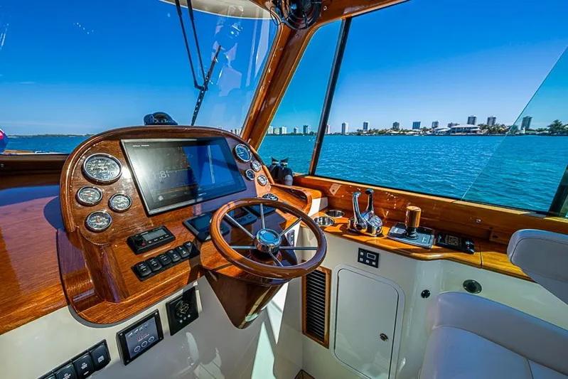 Odelay Yacht Photos Pics 2016 Hinckley Picnic Boat MKIII helm with city skyline view.