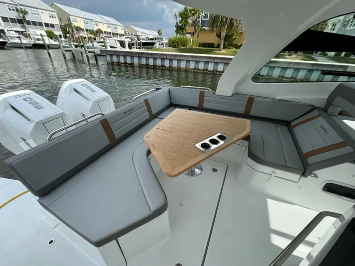  Yacht Photos Pics 2024 Beneteau Gran Turismo 32 yacht with sleek seating and modern design in a marina setting.