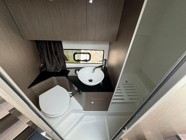  Yacht Photos Pics 2024 Beneteau Gran Turismo 32 bathroom with modern fixtures and compact design.