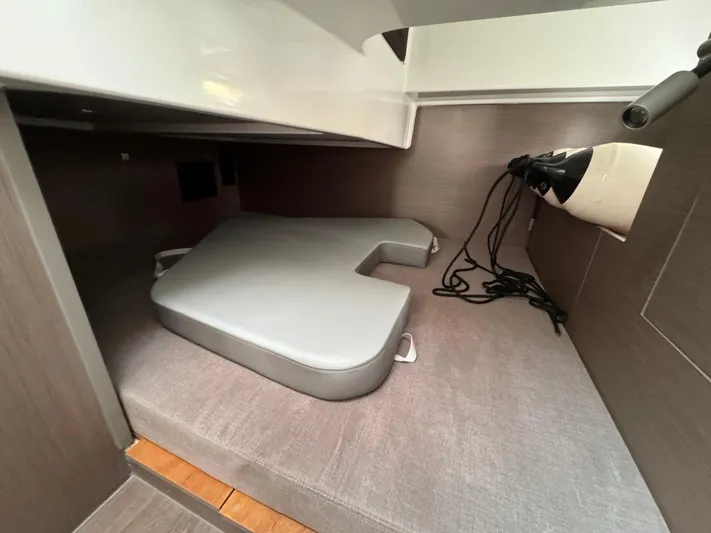  Yacht Photos Pics 2024 Beneteau Gran Turismo 32 cabin interior with cushions and storage space.