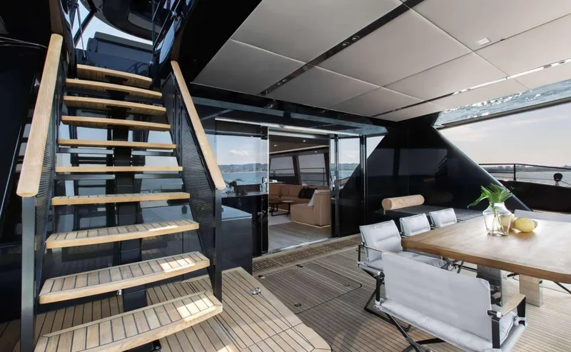 Grayone Yacht Photos Pics Luxurious Sunreef 80 sailing yacht interior with elegant dining area and wooden staircase, 2020 model.