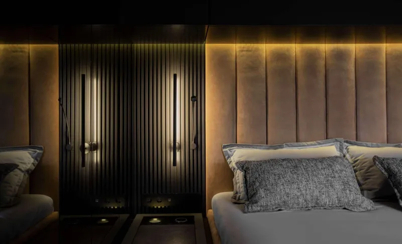 Grayone Yacht Photos Pics Luxurious interior of 2020 Sunreef 80 sailing yacht with elegant lighting and plush bedding.