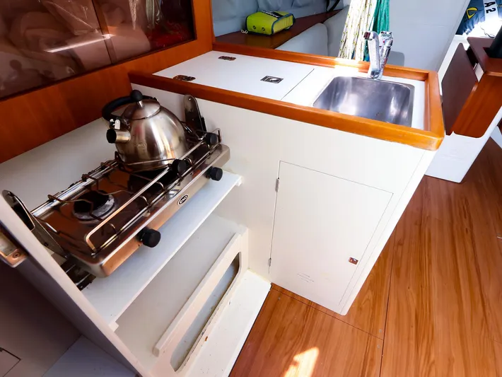  Yacht Photos Pics Compact galley in 2020 J Boats J/99 with stove, kettle, and sink.