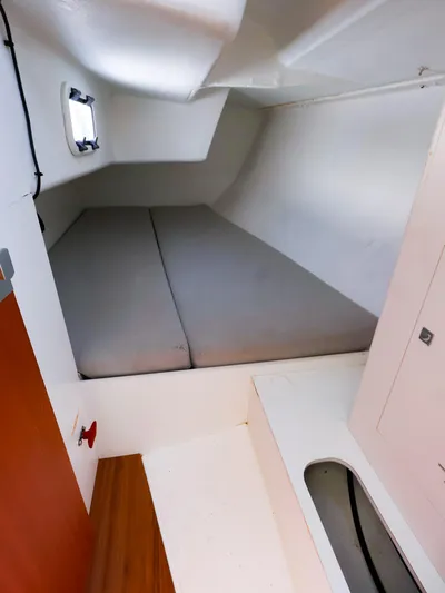  Yacht Photos Pics 2020 J Boats J/99 cabin interior with a compact sleeping area and window.