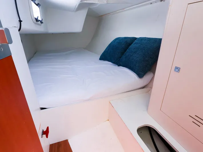  Yacht Photos Pics 2020 J Boats J/99 cabin interior with cozy bed and blue pillows.
