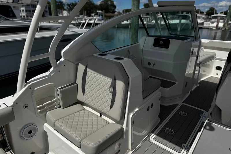 Luna Sea Yacht Photos Pics 2023 Pursuit DC 266 Dual Console boat interior with cushioned seating and sleek design.