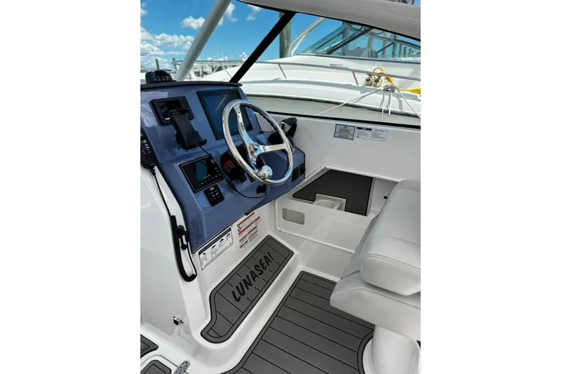 Luna Sea Yacht Photos Pics 2023 Pursuit DC 266 Dual Console boat interior with steering wheel and control panel.