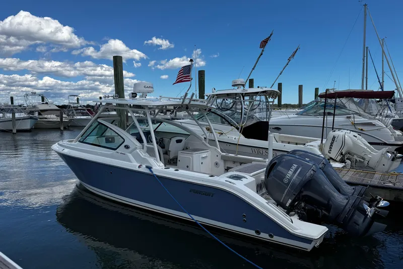 Luna Sea Yacht Photos Pics 2023 Pursuit DC 266 Dual Console boat docked in marina under blue sky.