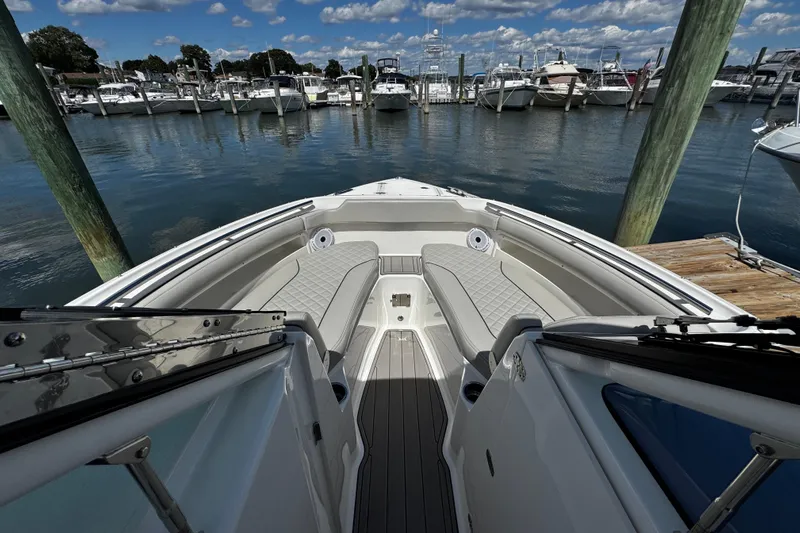 Luna Sea Yacht Photos Pics 2023 Pursuit DC 266 Dual Console boat docked at marina under blue sky.