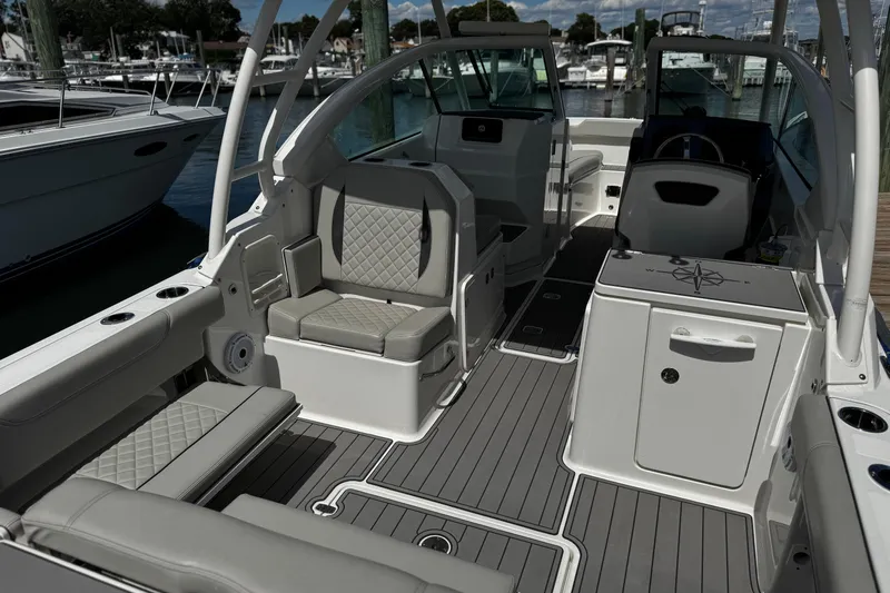 Luna Sea Yacht Photos Pics 2023 Pursuit DC 266 Dual Console boat interior with seating and storage, docked at marina.
