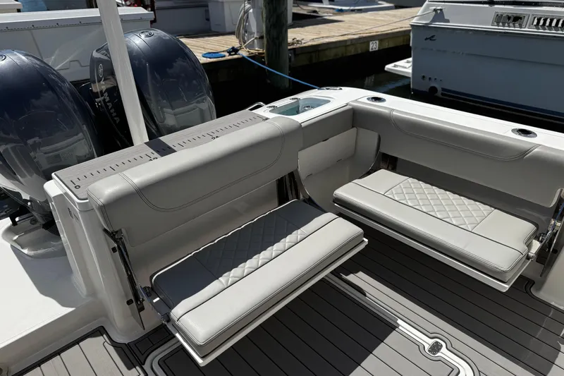 Luna Sea Yacht Photos Pics 2023 Pursuit DC 266 Dual Console boat with cushioned seating and twin engines at dock.