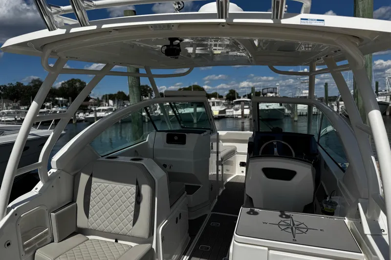 Luna Sea Yacht Photos Pics 2023 Pursuit DC 266 Dual Console boat interior at marina, featuring seating and helm.