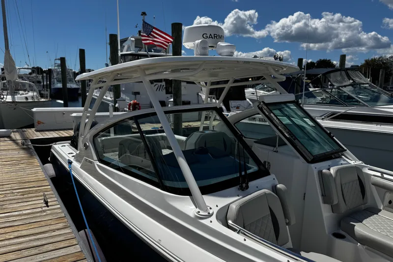 Luna Sea Yacht Photos Pics 2023 Pursuit DC 266 Dual Console boat docked at marina under blue sky.