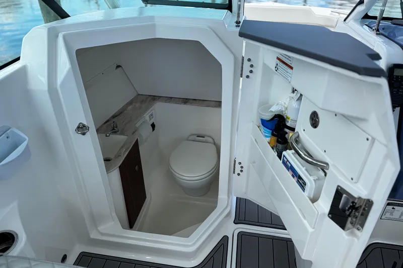 Luna Sea Yacht Photos Pics 2023 Pursuit DC 266 Dual Console boat interior with compact bathroom amenities.