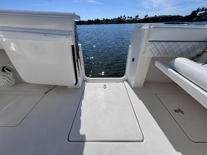 Herediterry Yacht Photos Pics 2017 Intrepid 375 FE boat deck with open door, overlooking calm water.