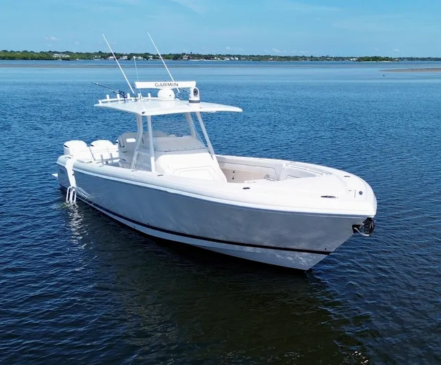 Herediterry Yacht Photos Pics 2017 Intrepid 375 FE boat on calm water, featuring sleek design and advanced navigation equipment.
