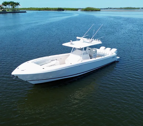 Herediterry Yacht Photos Pics 2017 Intrepid 375 FE boat on calm water, clear sky, and lush shoreline.