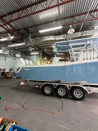  Yacht Photos Pics 2025 Invincible 36 Open boat in warehouse, on a triple-axle trailer.