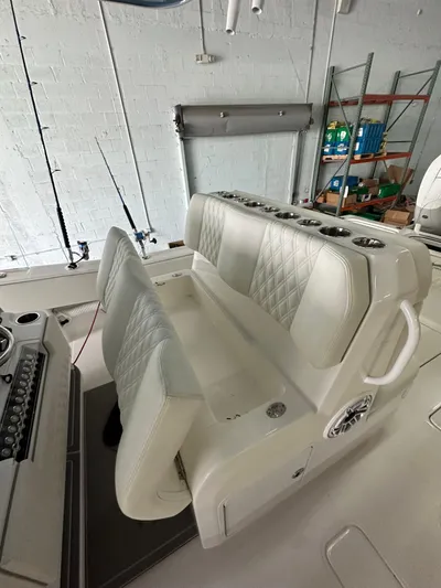  Yacht Photos Pics 2025 Invincible 36 Open boat interior with white cushioned seating and rod holders.