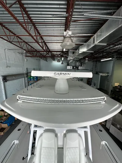  Yacht Photos Pics 2025 Invincible 36 Open boat with Garmin radar in a warehouse setting.