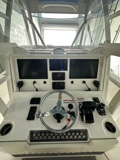  Yacht Photos Pics 2025 Invincible 36 Open boat dashboard with dual screens and modern controls.
