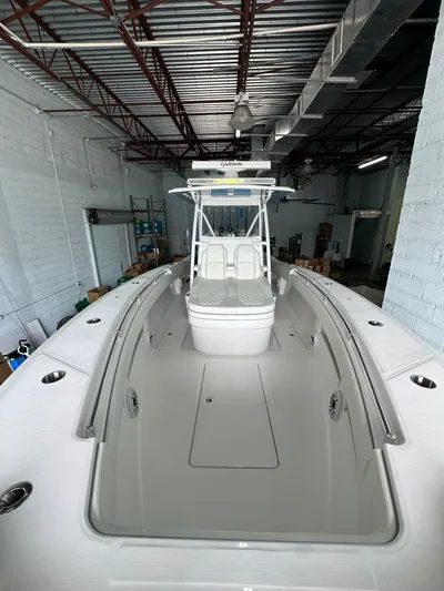  Yacht Photos Pics 2025 Invincible 36 Open boat in a warehouse, showcasing sleek design and spacious deck.