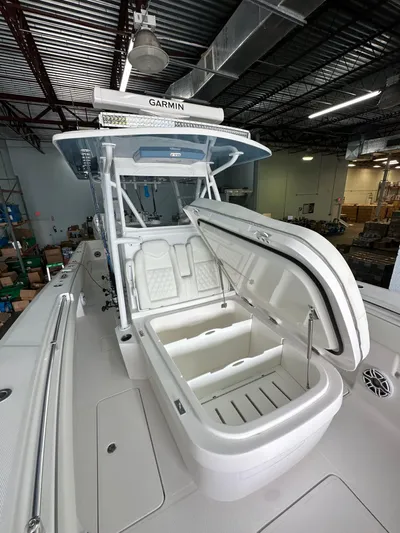  Yacht Photos Pics 2025 Invincible 36 Open boat with open storage compartment in a warehouse setting.