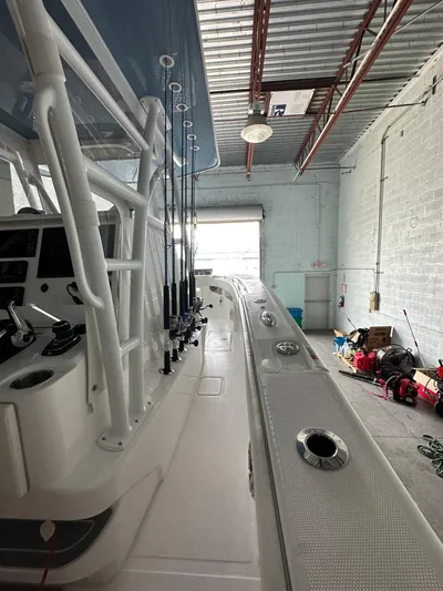  Yacht Photos Pics 2025 Invincible 36 Open boat in a garage, showcasing fishing rod holders and sleek design.