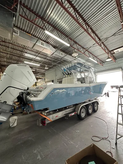  Yacht Photos Pics 2025 Invincible 36 Open boat in a workshop on a trailer.