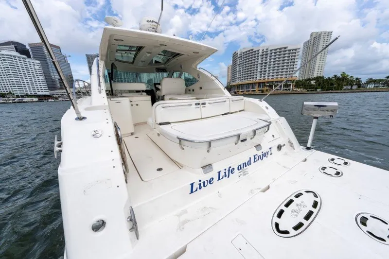  Yacht Photos Pics 2009 Sea Ray 43 Sundancer yacht docked with city skyline backdrop.
