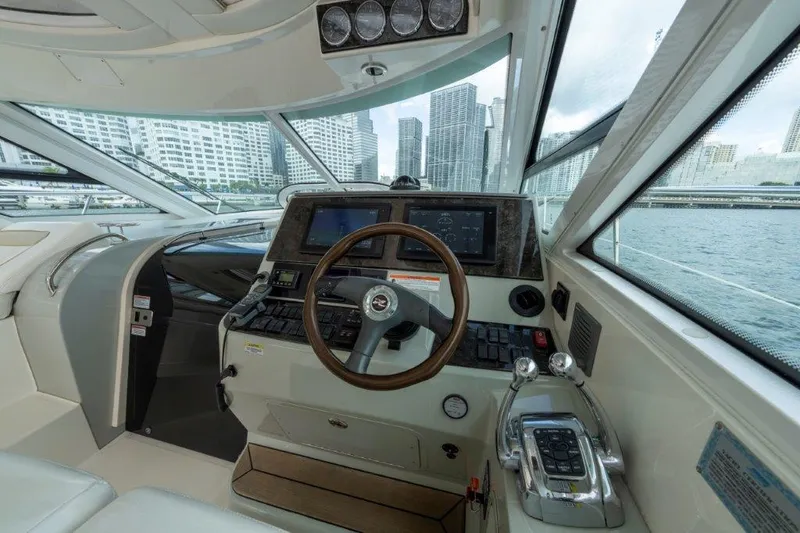  Yacht Photos Pics 2009 Sea Ray 43 Sundancer helm with city skyline view.