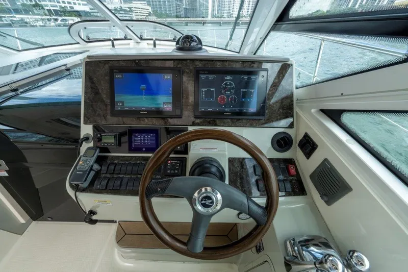  Yacht Photos Pics 2009 Sea Ray 43 Sundancer helm with navigation screens and steering wheel.