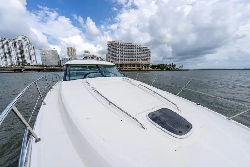 Yacht Photos Pics 2009 Sea Ray 43 Sundancer yacht cruising near urban waterfront skyline.