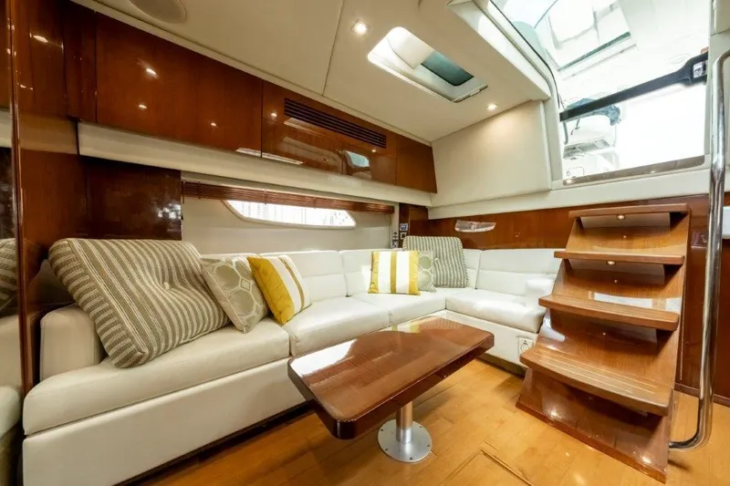  Yacht Photos Pics Luxurious interior of 2009 Sea Ray 43 Sundancer yacht with plush seating and wooden accents.