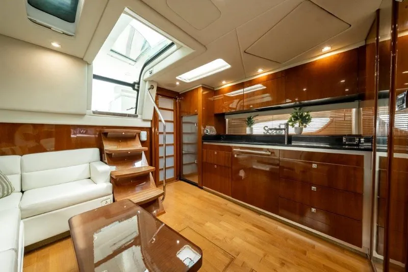  Yacht Photos Pics Luxurious interior of 2009 Sea Ray 43 Sundancer yacht with wood finishes and modern design.