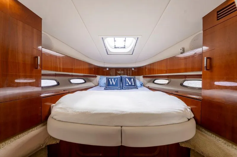  Yacht Photos Pics Luxurious cabin interior of 2009 Sea Ray 43 Sundancer yacht with wood paneling and skylight.