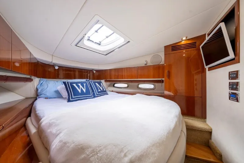  Yacht Photos Pics Luxurious cabin interior of 2009 Sea Ray 43 Sundancer yacht with cozy bed and TV.