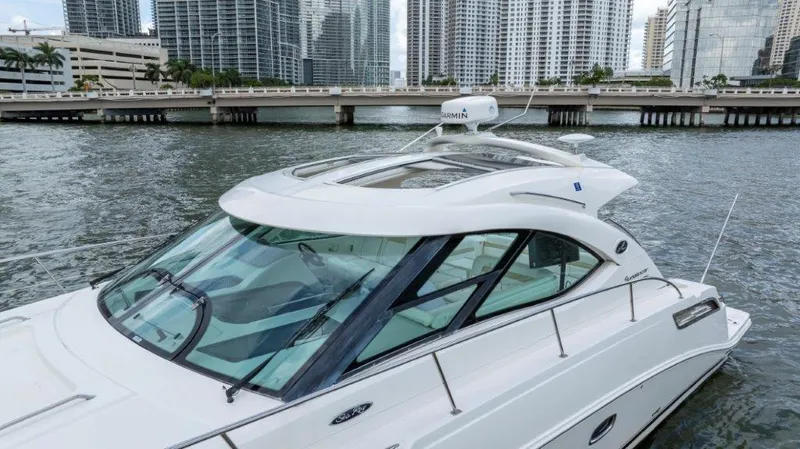  Yacht Photos Pics 2009 Sea Ray 43 Sundancer yacht cruising near city skyline.