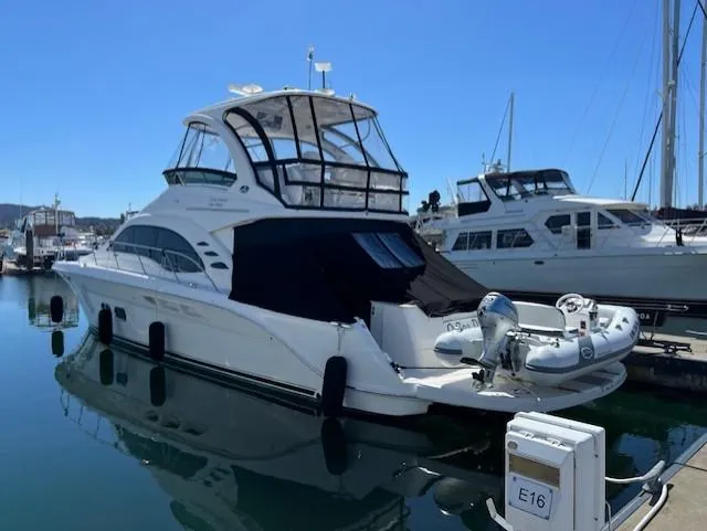 O Sea D Yacht Photos Pics 2010 Sea Ray 520 Sedan Bridge yacht docked in marina, featuring sleek design and inflatable tender.