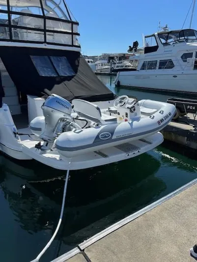 O Sea D Yacht Photos Pics 2010 Sea Ray 520 Sedan Bridge with dinghy, docked at marina.