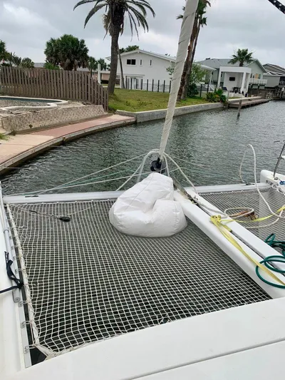 Esperanza Yacht Photos Pics 2019 Lagoon 380 S2 4/2 catamaran docked by a canal with netting and ropes.