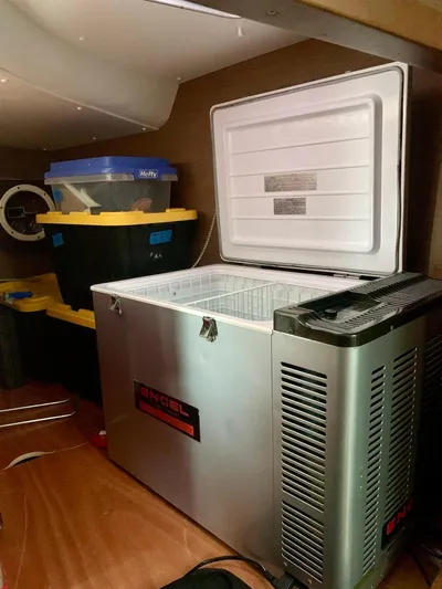 Esperanza Yacht Photos Pics Open freezer in 2019 Lagoon 380 S2 4/2 yacht interior with storage bins nearby.